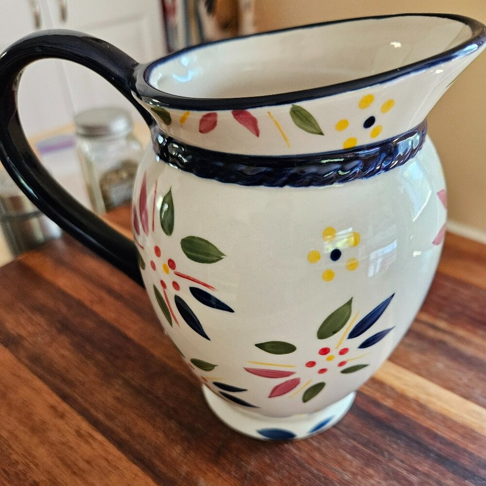 temptations old world blue and yellow pitcher